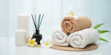 Spa accessory composition set in day spa hotel , beauty wellness center . Spa product are placed in luxury spa resort room , ready for massage therapy from professional service .