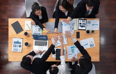 Top-view business team of financial data analysis meeting with business intelligence, report paper and dashboard on laptop for marketing strategy. Business people working together in office of harmony