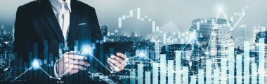 Businessman analyst working with digital finance business data graph showing technology of investment strategy for perceptive financial business decision. Digital economic analysis technology concept.