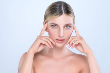 Alluring beautiful woman with perfect smooth and clean skin portrait in isolated background. Beauty hand gesture with expressive facial expression for skincare treatment product or spa.