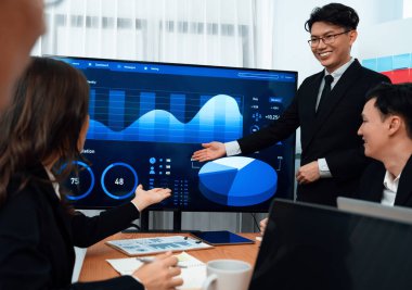 Confidence and asian businessman give presentation on financial analyzed by business intelligence in dashboard report to other people in board room meeting to promote harmony in workplace.