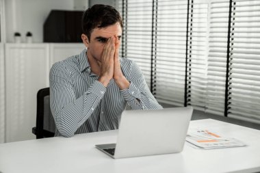 The exhausted office worker who was once competent is now confused. Boredom and fatigue in the office due to overtime working.