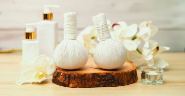 Spa accessory composition set in day spa hotel , beauty wellness center . Spa product are placed in luxury spa resort room , ready for massage therapy from professional service .