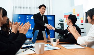 Businesspeople shake hand after successful agreement or meeting. Office worker colleague handshake with business team leader manager for strong teamwork in office to promote harmony and unity concept.
