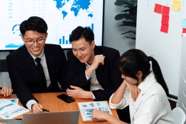 Business team of financial data analysis meeting with business intelligence, report paper and dashboard on laptop for marketing strategy. Business people working together to promote harmony in office.
