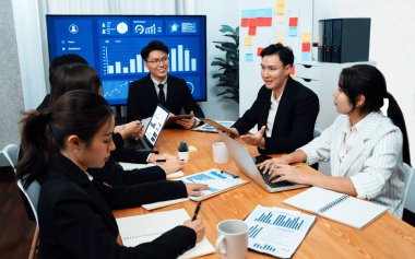 Business team of financial data analysis meeting with business intelligence, report paper and dashboard on laptop for marketing strategy. Business people working together to promote harmony in office.