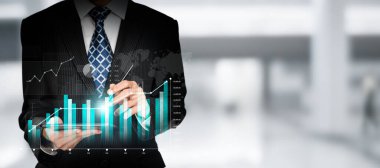 Businessman analyst working with digital finance business data graph showing technology of investment strategy for perceptive financial business decision. Digital economic analysis technology concept.