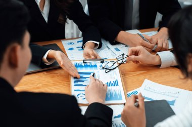 Business team of financial data analysis meeting with business intelligence, report paper and dashboard on laptop for marketing strategy. Business people working together to promote harmony in office.