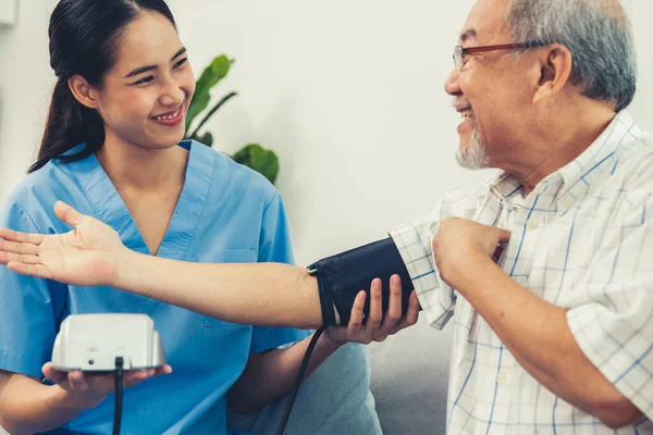 Contented Retired Man Having Blood Pressure Check His Personal Caregiver — Foto de Stock