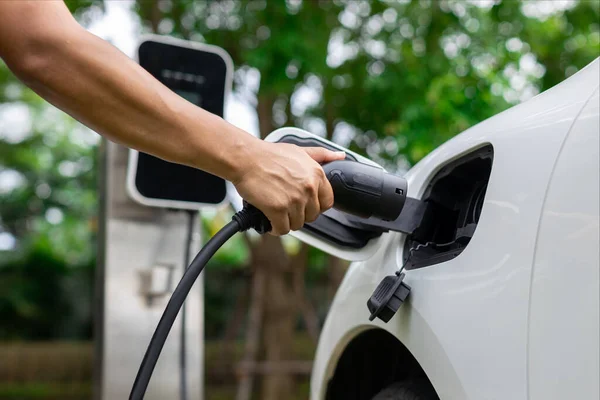 Hand Inserting Charging Plug Electric Vehicle Focus Shot Blurred Background — Stockfoto