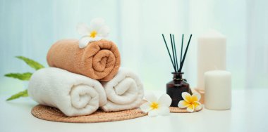 Spa accessory composition set in day spa hotel , beauty wellness center . Spa product are placed in luxury spa resort room , ready for massage therapy from professional service .
