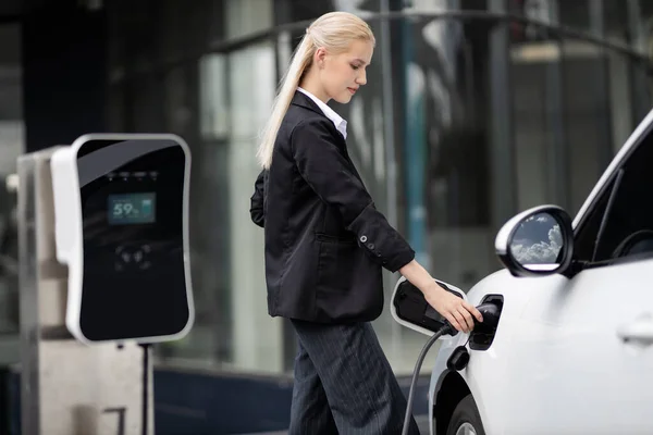 Progressive Businesswoman Insert Charger Plug Charging Station Her Electric Vehicle — Stockfoto