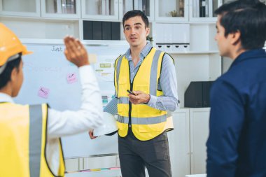 A team of investor and competent engineers brainstorming on the whiteboard to find new ideas and making plans. The idea of a team gather ideas together.