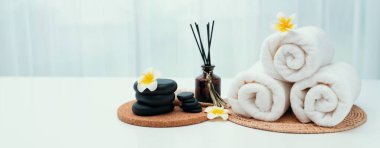 Spa accessory composition set in day spa hotel , beauty wellness center . Spa product are placed in luxury spa resort room , ready for massage therapy from professional service .