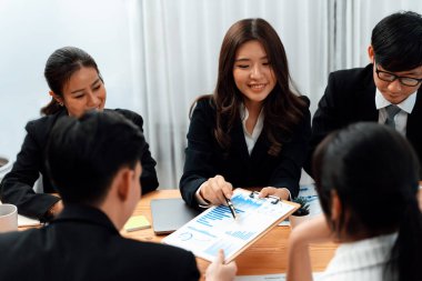 Business team of financial data analysis meeting with business intelligence, report paper and dashboard on laptop for marketing strategy. Business people working together to promote harmony in office.
