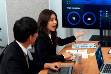 Business team of financial data analysis meeting with business intelligence, report paper and dashboard on laptop for marketing strategy. Business people working together to promote harmony in office.