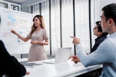 Competent office workers from various nationalities are debating, discussing and brainstorming in the meeting room. A group of employees is collaborating to achieve their business objectives.