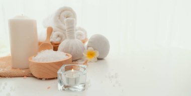 Spa accessory composition set in day spa hotel , beauty wellness center . Spa product are placed in luxury spa resort room , ready for massage therapy from professional service .