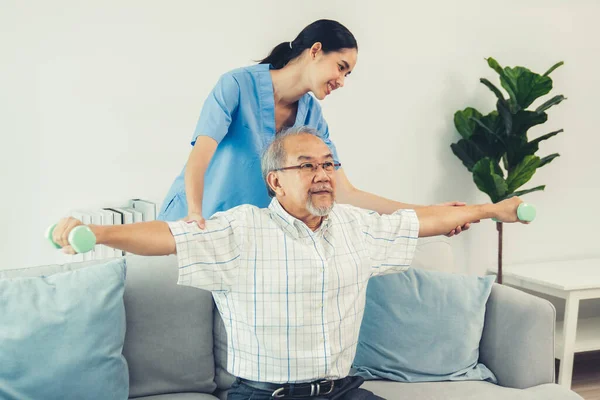 Contented Senior Patient Doing Physical Therapy Help His Caregiver Senior — Stok fotoğraf
