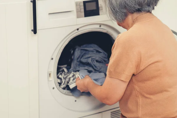 Contented Senior Housewife Doing Laundry Laundry Room Clothes Washing Machine — Foto de Stock