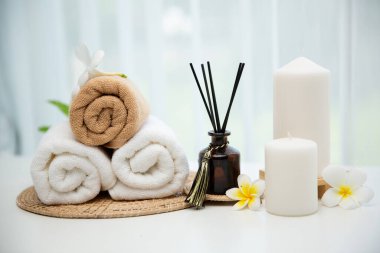 Spa accessory composition set in day spa hotel , beauty wellness center . Spa product are placed in luxury spa resort room , ready for massage therapy from professional service .