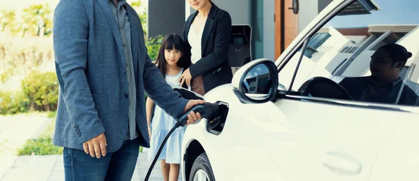 Progressive Young Parents Daughter Electric Vehicle Home Charging Station Green — Stock fotografie
