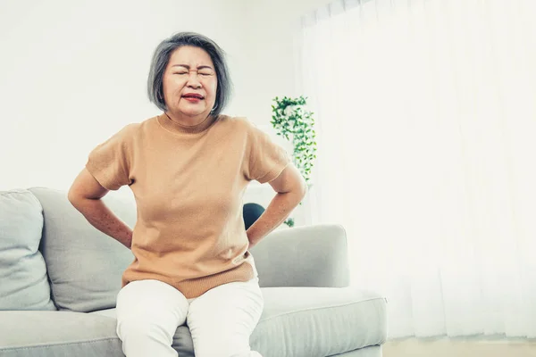 Agonizing Senior Woman Experiencing Back Pain While Sitting Her Sofa — Foto de Stock