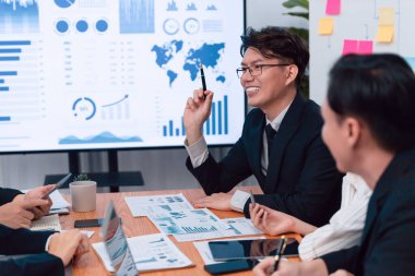 Business team of financial data analysis meeting with business intelligence, report paper and dashboard on laptop for marketing strategy. Business people working together to promote harmony in office.