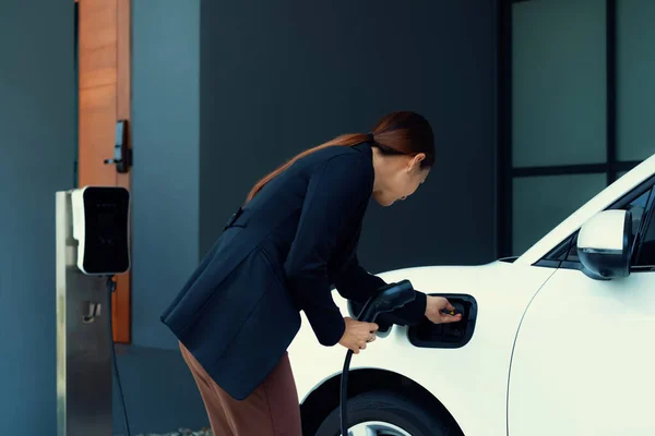 Progressive Woman Install Cable Plug Her Electric Car Home Charging — 图库照片