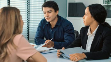 A young female asian candidate tries to impress her interviewer by being competent. International company, multicultural environment in workplace.