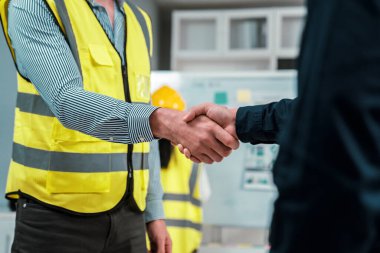 After concluding the meeting, competent investor shakes hands with engineer. Concept of the agreement between engineers and investors.