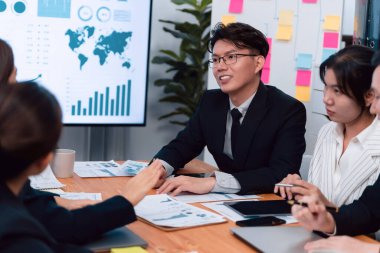 Business team of financial data analysis meeting with business intelligence, report paper and dashboard on laptop for marketing strategy. Business people working together to promote harmony in office.