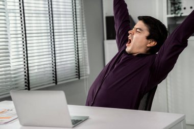 The exhausted asian office worker who was once competent is now confused. Overtime work is causing boredom and exhaustion in the workplace.