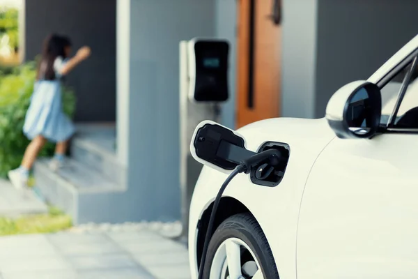 Focus Car Recharging Battery Home Charging Station Blurred Girl Running — Foto Stock