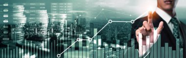 Businessman analyst working with digital finance business data graph showing technology of investment strategy for perceptive financial business decision. Digital economic analysis technology concept.