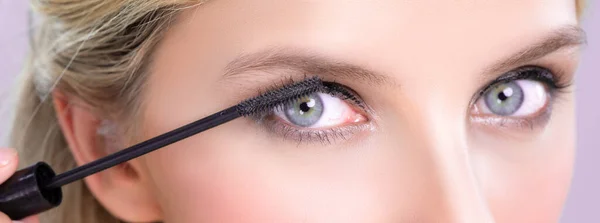 Closeup Woman Blond Hair Putting Alluring Black Mascara Brush Hand — Photo