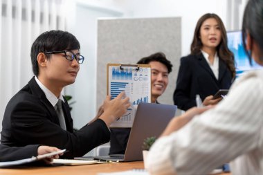 Business team of financial data analysis meeting with business intelligence, report paper and dashboard on laptop for marketing strategy. Business people working together to promote harmony in office.