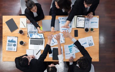 Top-view business team of financial data analysis meeting with business intelligence, report paper and dashboard on laptop for marketing strategy. Business people working together in office of harmony