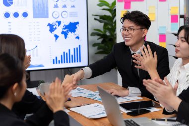 Businesspeople shake hand after successful agreement or meeting. Office worker colleague handshake with business team leader manager for strong teamwork in office to promote harmony and unity concept.