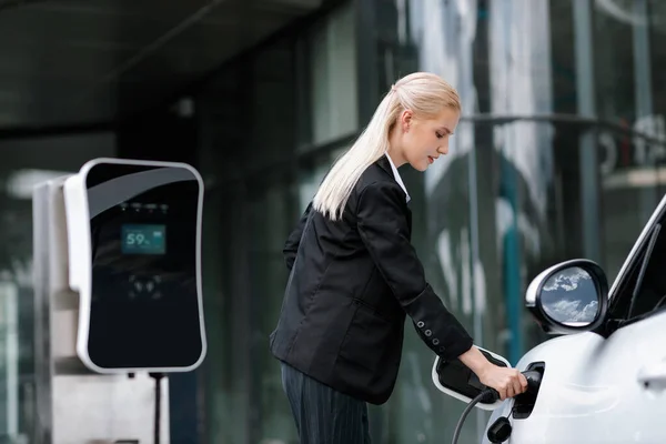 Progressive Businesswoman Insert Charger Plug Charging Station Her Electric Vehicle —  Fotos de Stock