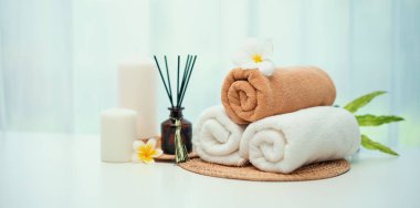 Spa accessory composition set in day spa hotel , beauty wellness center . Spa product are placed in luxury spa resort room , ready for massage therapy from professional service .