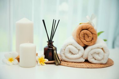 Spa accessory composition set in day spa hotel , beauty wellness center . Spa product are placed in luxury spa resort room , ready for massage therapy from professional service .