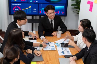 Business team of financial data analysis meeting with business intelligence, report paper and dashboard on laptop for marketing strategy. Business people working together to promote harmony in office.
