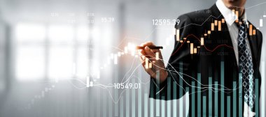 Businessman analyst working with digital finance business data graph showing technology of investment strategy for perceptive financial business decision. Digital economic analysis technology concept.