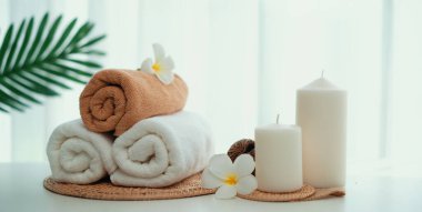 Spa accessory composition set in day spa hotel , beauty wellness center . Spa product are placed in luxury spa resort room , ready for massage therapy from professional service .