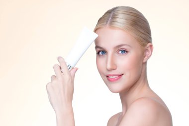 Closeup personable beautiful perfect natural skin woman hold mockup tube moisturizer cream for skincare treatment product advertising expressive facial and gesture expression in isolated background.