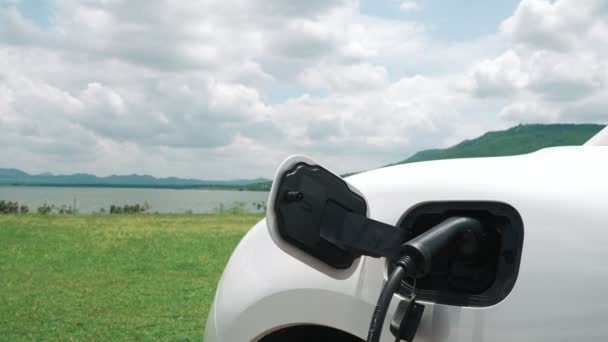 Progressief Concept Van Elektrische Auto Auto Naast Laadstation Natuurlijke Achtergrond — Stockvideo