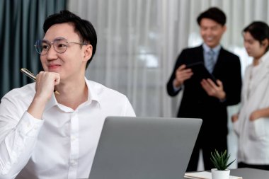 Portrait of focus young successful confident male manager, executive wearing business wear in harmony office arm crossed with blurred meeting background of colleagues, office worker.
