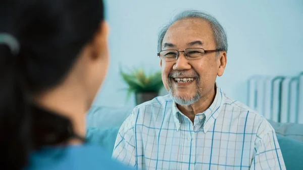 Young Female Doctor Inquires Personal Information Contented Senior Home Medical — Stock Photo, Image
