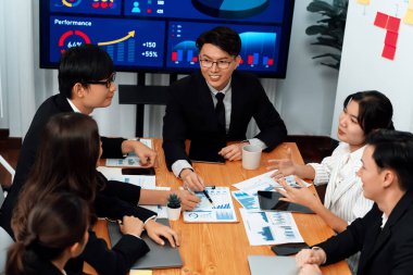 Business team of financial data analysis meeting with business intelligence, report paper and dashboard on laptop for marketing strategy. Business people working together to promote harmony in office.